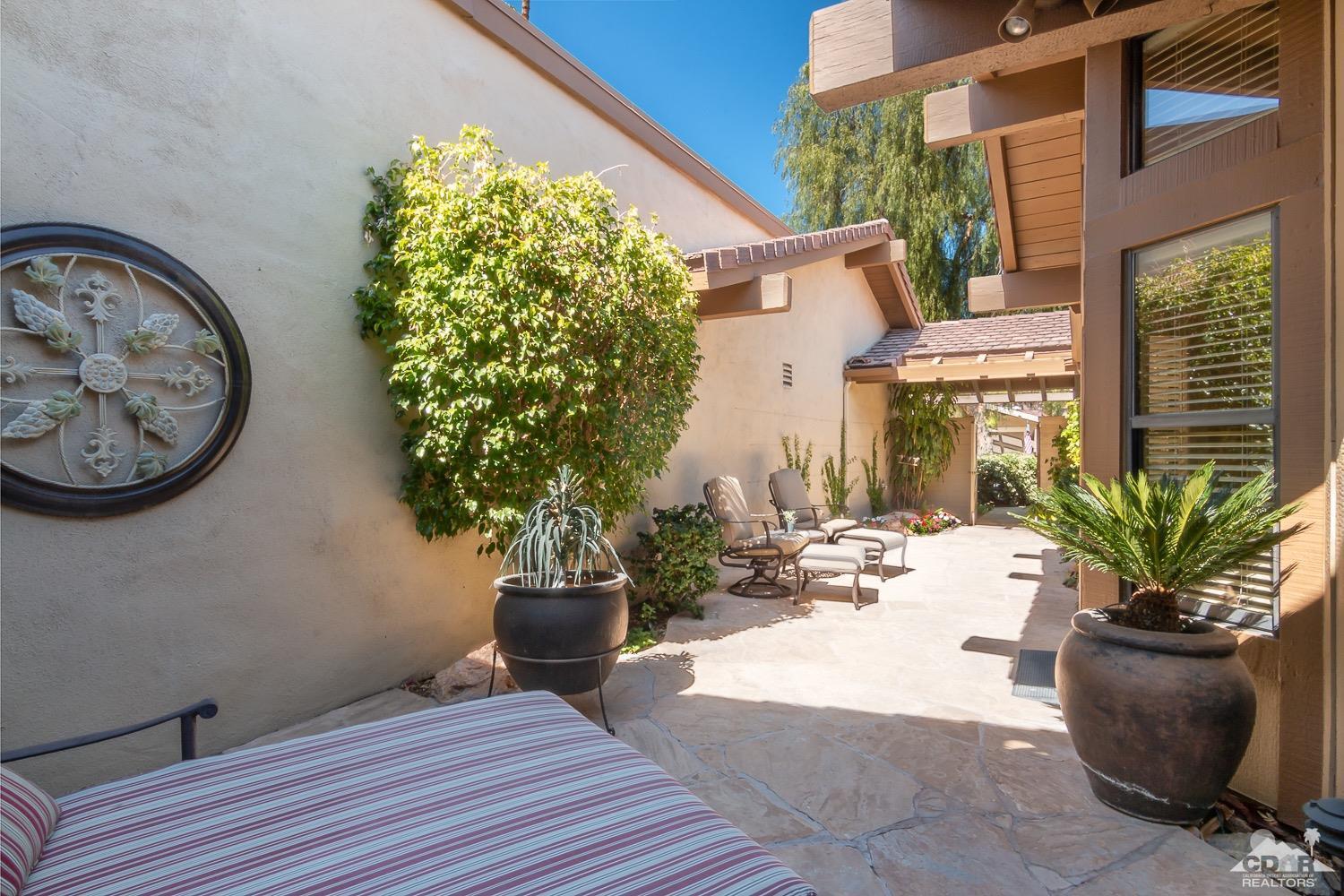 353 Red River Road Palm Desert, CA 92211 - Photo 26 of 28 a view of a house with a potted plant