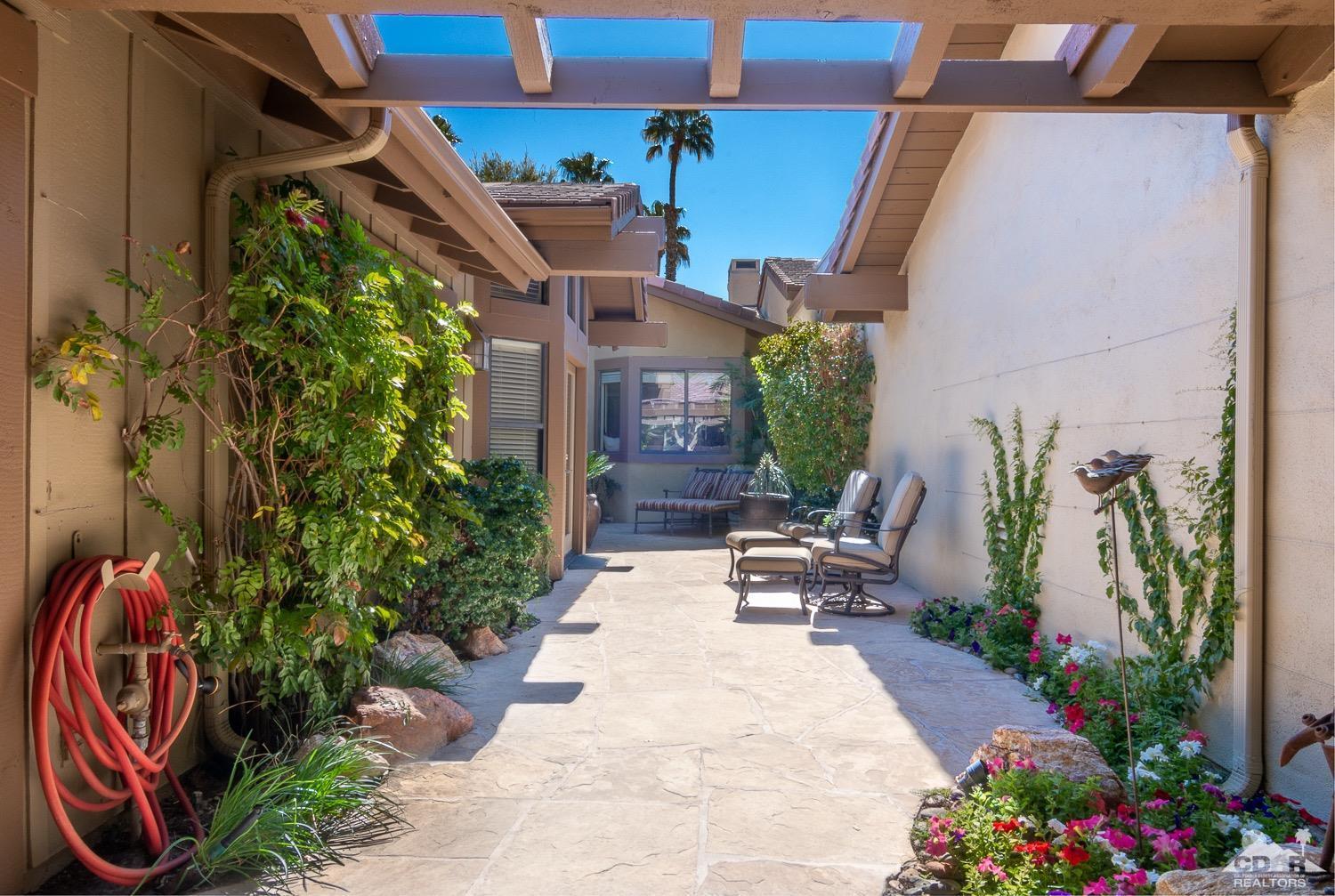 353 Red River Road Palm Desert, CA 92211 - Photo 27 of 28 a view of a patio with plants and table and chairs