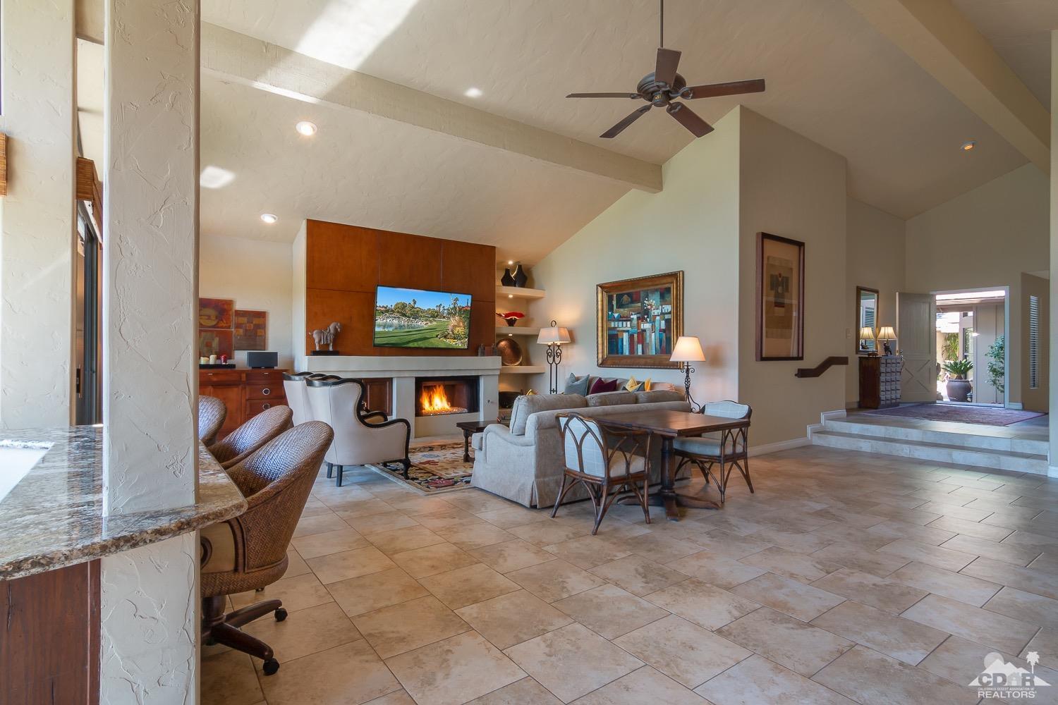 353 Red River Road Palm Desert, CA 92211 - Photo 10 of 28 a living room with furniture a flat screen tv and a dining table