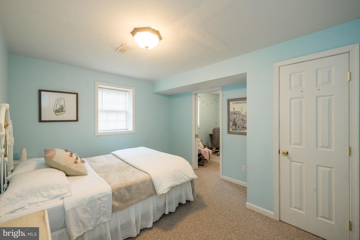 8339 Kines Road Warrenton, VA 20187 - Photo 12 of 19 a bedroom with a bed and a lamp