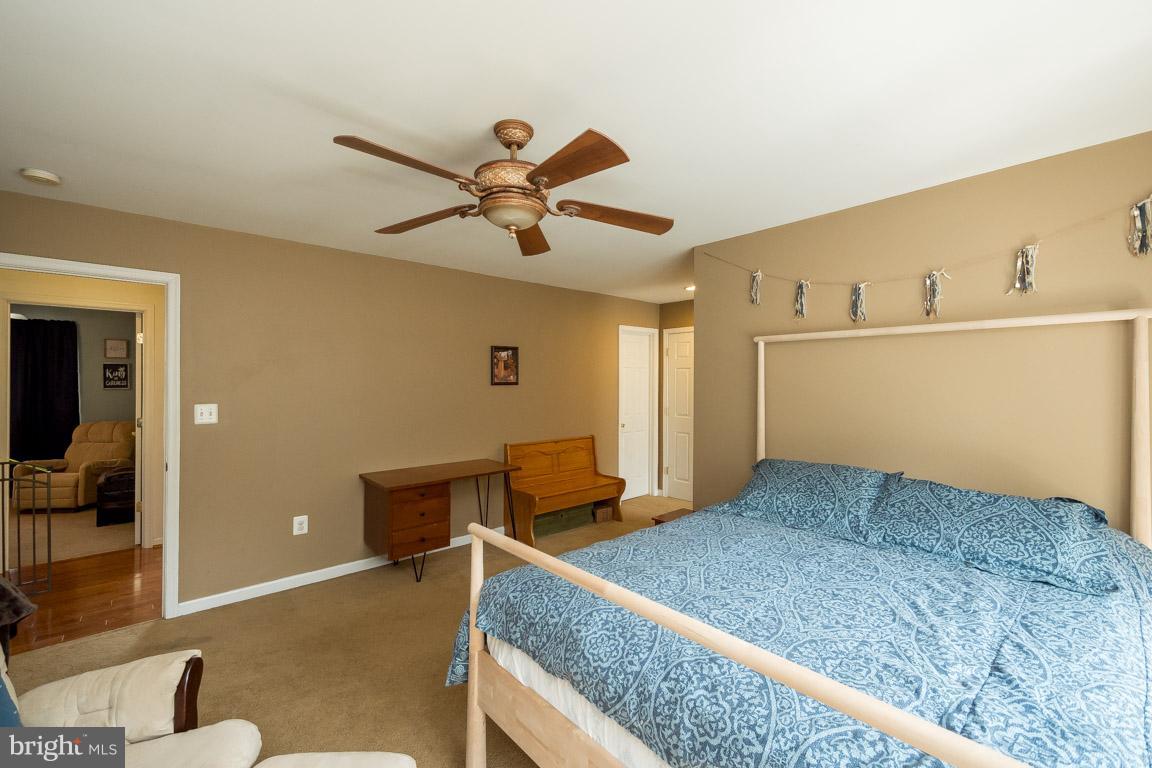 8339 Kines Road Warrenton, VA 20187 - Photo 13 of 19 a bedroom with a bed and a chandelier