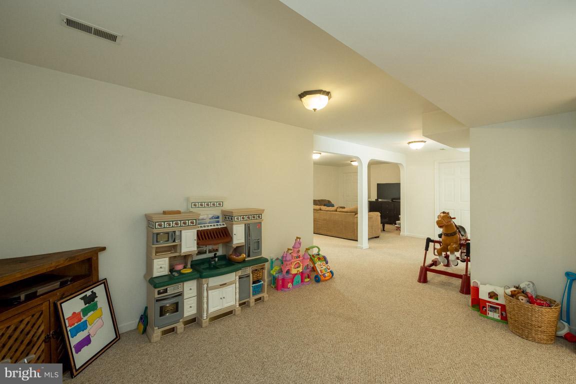 8339 Kines Road Warrenton, VA 20187 - Photo 18 of 19 a living room with furniture and a flat screen tv