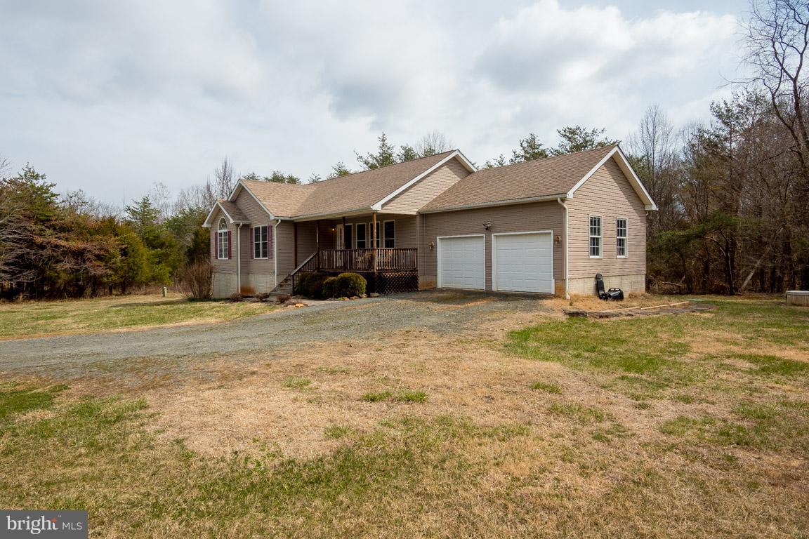 8339 Kines Road Warrenton, VA 20187 - Photo 2 of 19 a front view of a house with a garden and trees