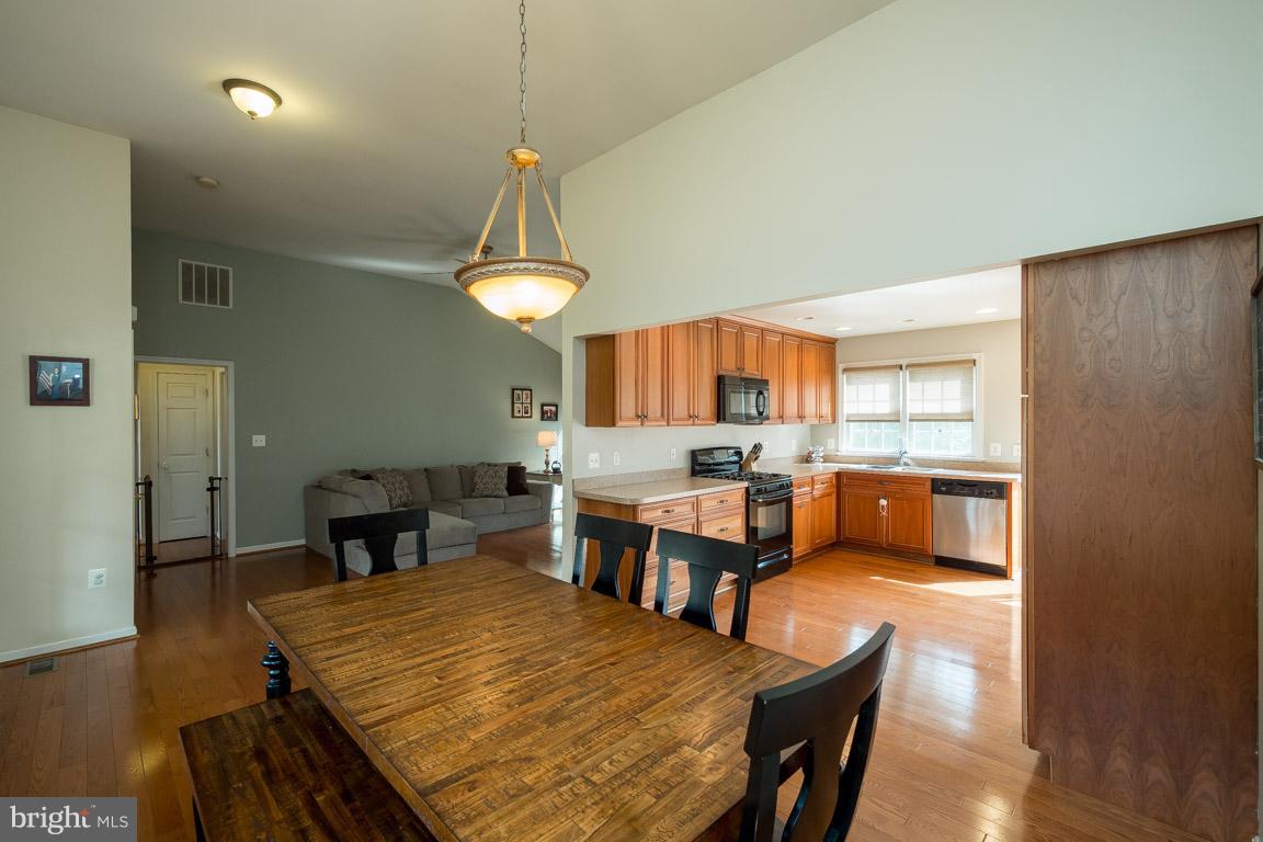 8339 Kines Road Warrenton, VA 20187 - Photo 6 of 19 a large kitchen with a table and chairs