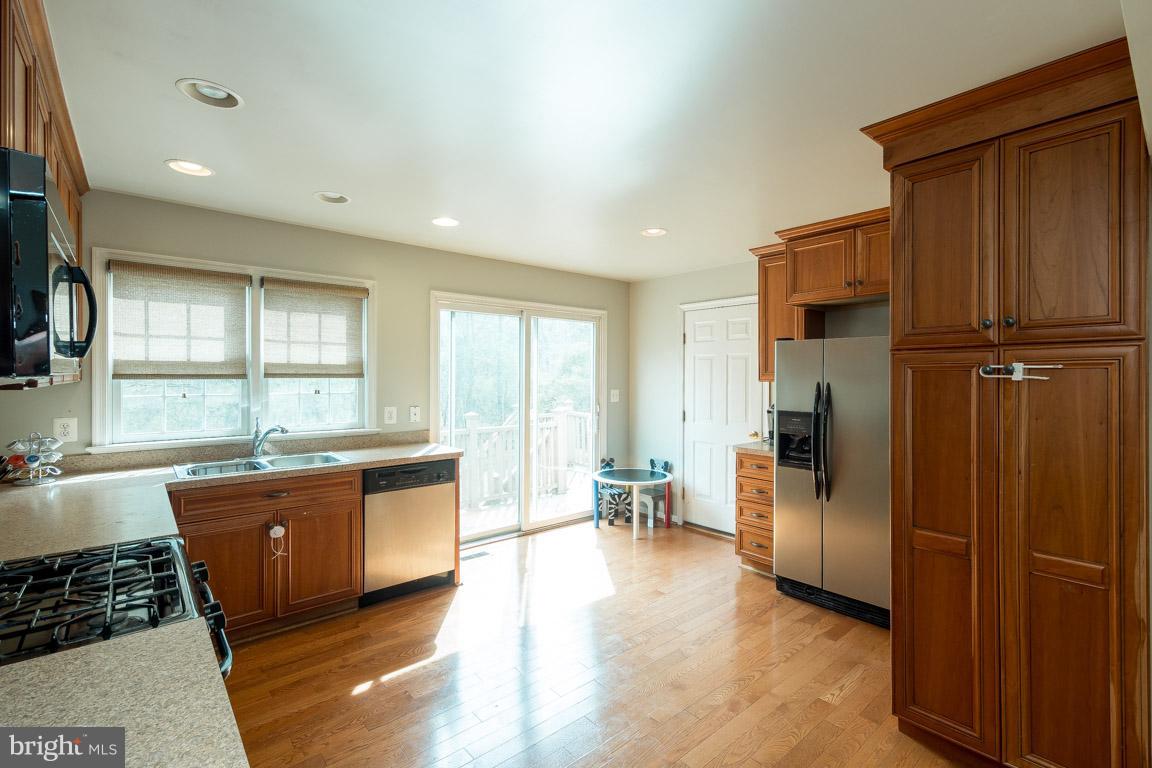 8339 Kines Road Warrenton, VA 20187 - Photo 8 of 19 a kitchen with stainless steel appliances granite countertop a refrigerator and a stove top oven