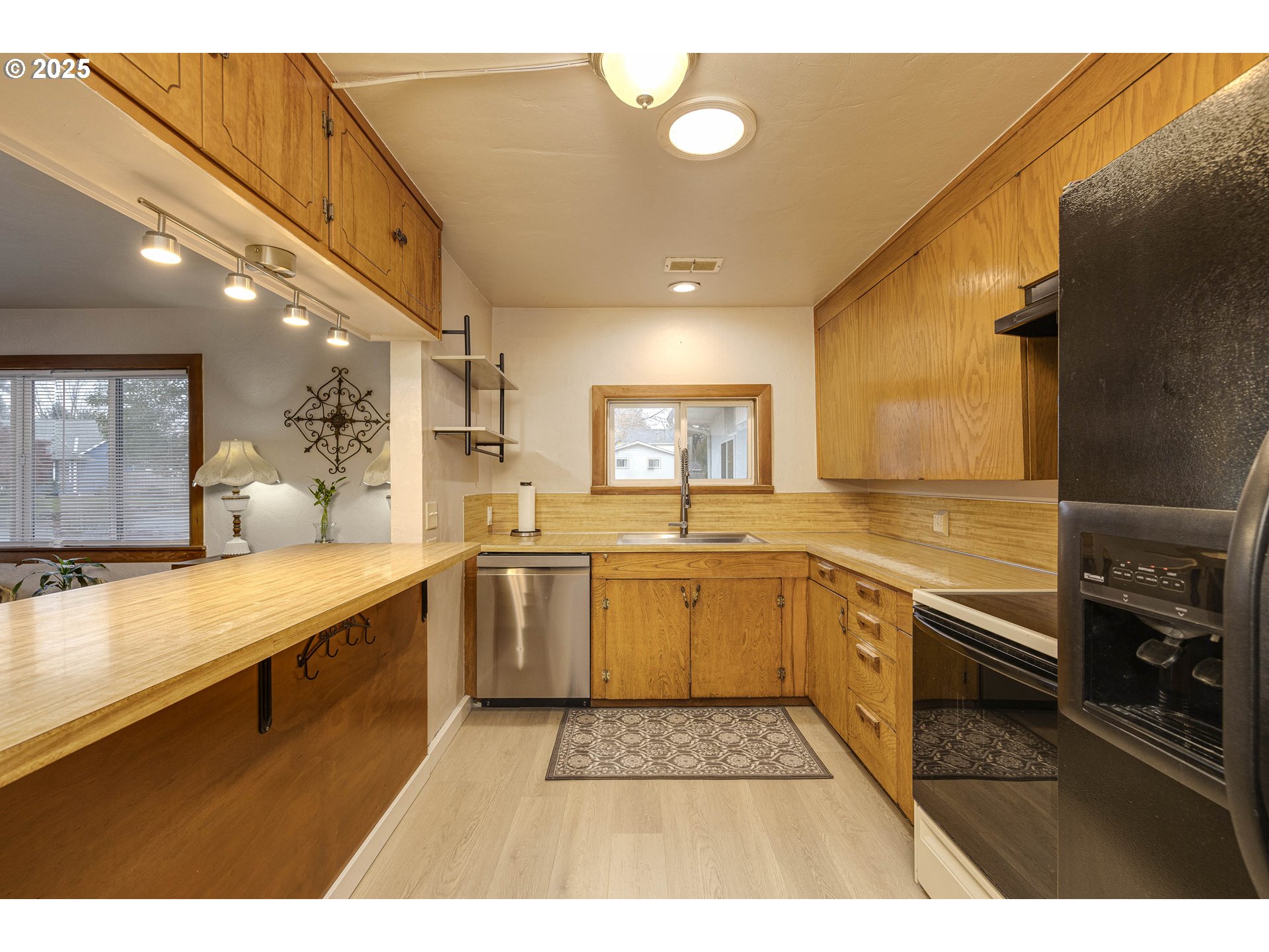 4911 15th Avenue North Keizer, OR 97303 - Photo 11 of 32 a large kitchen with stainless steel appliances granite countertop a sink and cabinets