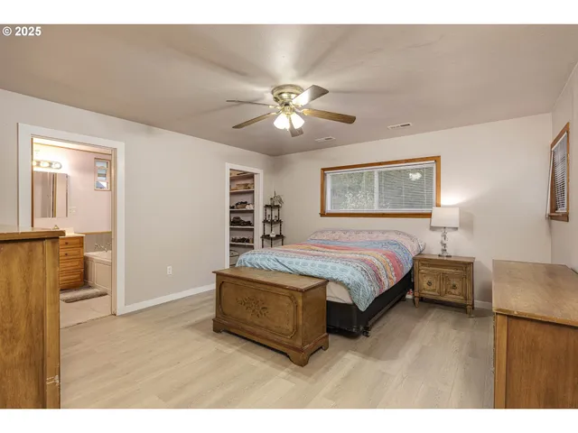 a spacious bedroom with a bed and a chandelier