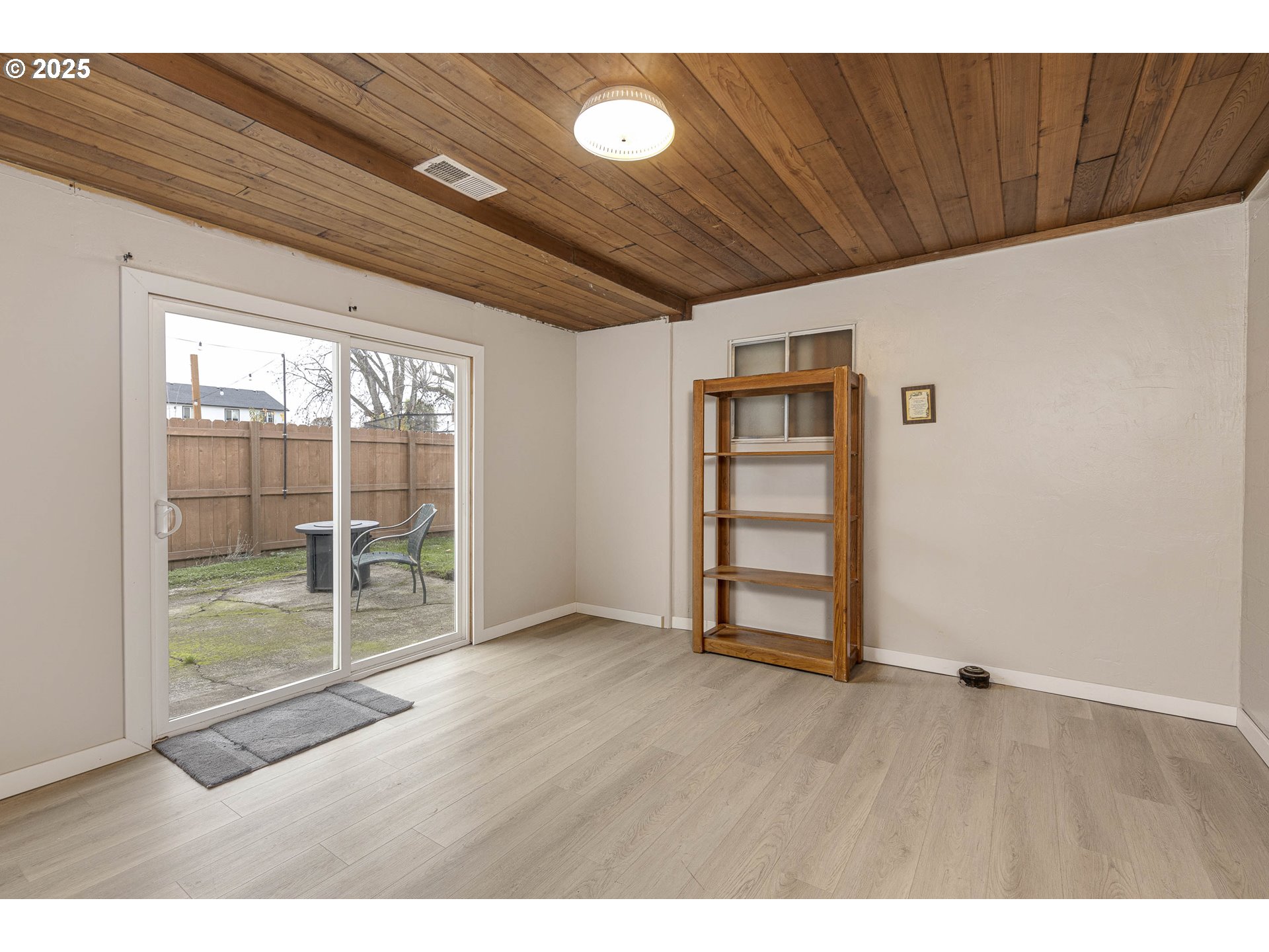 4911 15th Avenue North Keizer, OR 97303 - Photo 23 of 32 a view of an empty room with wooden floor and a window