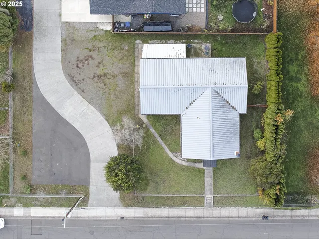 an aerial view of a house with a yard