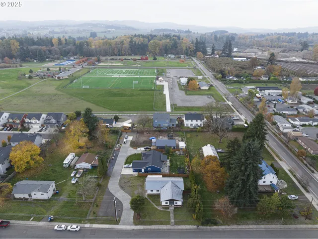 an aerial view of a houses with a yard