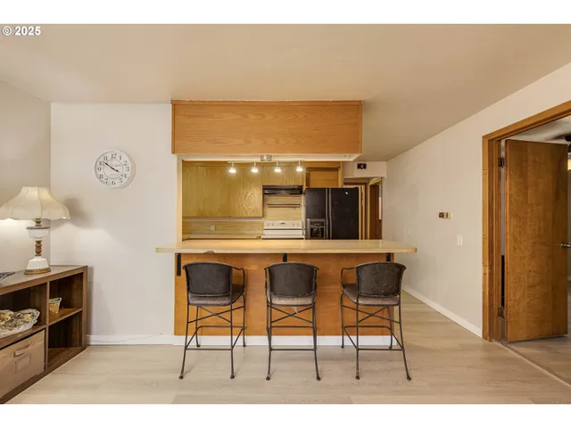 a living room with a table and a wooden floor