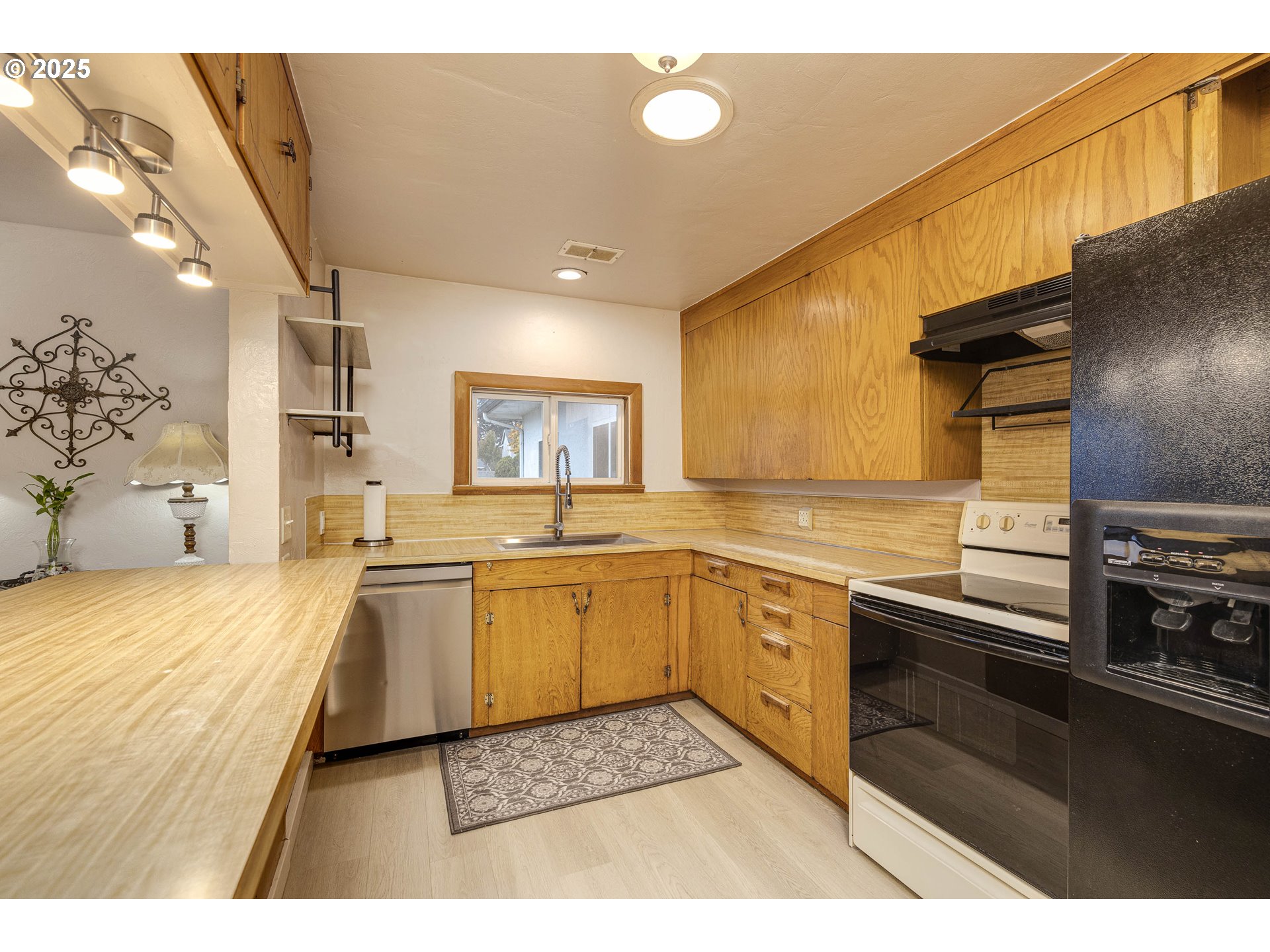 4911 15th Avenue North Keizer, OR 97303 - Photo 10 of 32 a open kitchen with stainless steel appliances granite countertop a sink dishwasher stove and oven