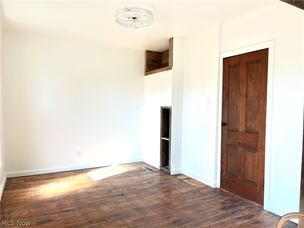 12972 Gilmore Road Southeast Port Washington, OH 43837 - Photo 26 of 50 Unfurnished bedroom featuring dark wood-type flooring and baseboards