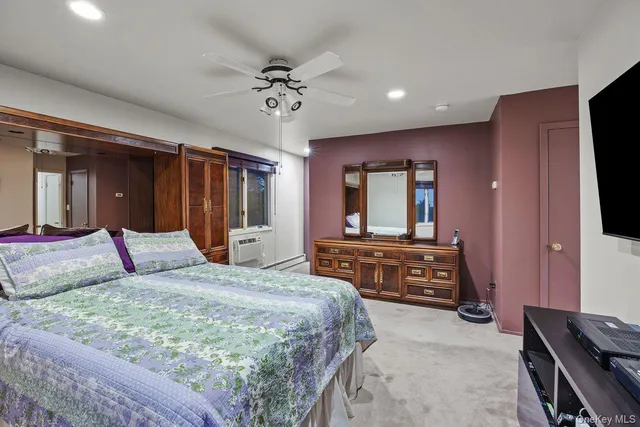 a bedroom with a large bed and a dresser