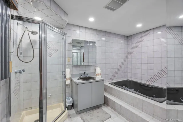 a bathroom with a granite countertop sink a toilet and shower