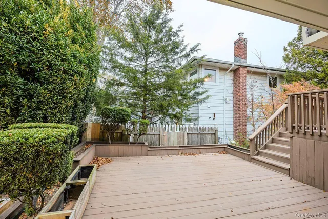 a view of a house with backyard and deck
