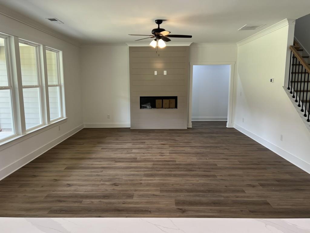 144 Tomahawk Trail Good Hope, GA 30641 - Photo 11 of 51 an empty room with wooden floor and windows