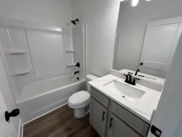 a bathroom with a sink toilet tub and shower