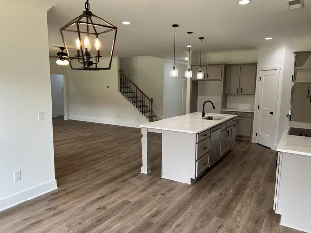 a bathroom with a sink a large mirror and vanity