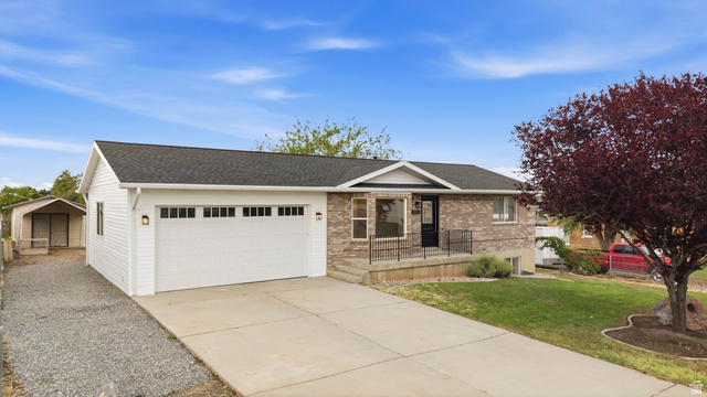 643 East 400 North Payson, UT 84651 - Photo 1 of 1 Two-story residence featuring brick and horizontal siding, a two-car garage, and a concrete driveway