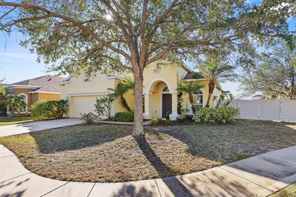 a view of a white house with a yard