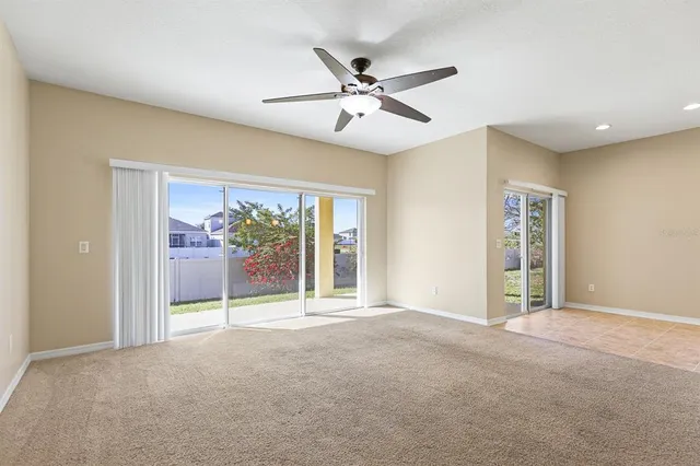 a view of a livingroom with a ceiling fan and window