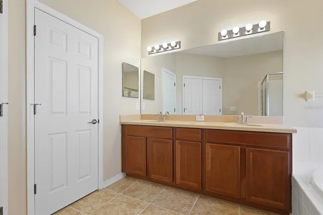 a bathroom with a double vanity sink and a mirror