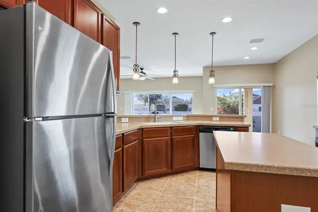 a kitchen with stainless steel appliances granite countertop a refrigerator a sink and a refrigerator