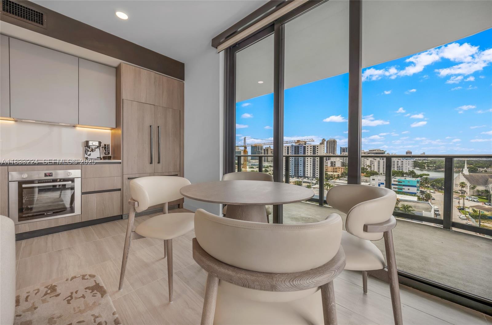580 72nd Street, Unit 910 Miami Beach, FL 33141 - Photo 34 of 60 a living room with furniture a floor to ceiling window and stainless steel appliances