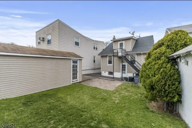 a view of a house with a yard and garage