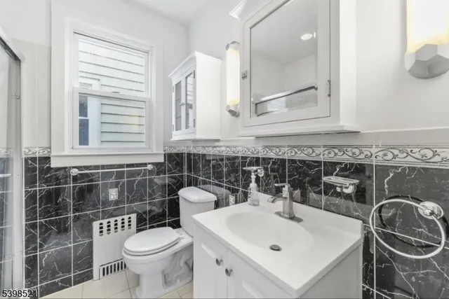 a bathroom with a sink a toilet and a mirror