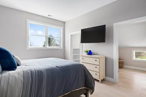 a bedroom with a bed and a flat screen tv