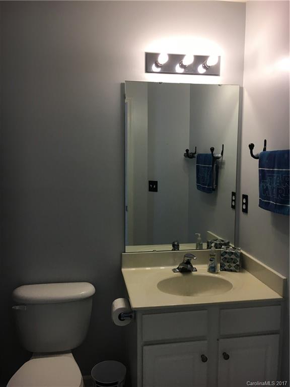 2126 Midnight Blue Lane, Unit 165 Fort Mill, SC 29708 - Photo 22 of 23 a bathroom with a toilet sink and mirror