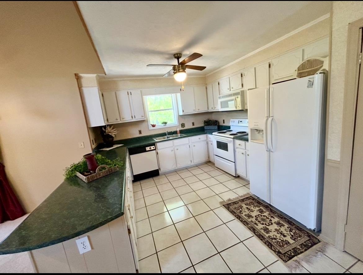 720 Riverside Lane Crump, TN 38327 - Photo 11 of 39 a kitchen with granite countertop a sink appliances and cabinets