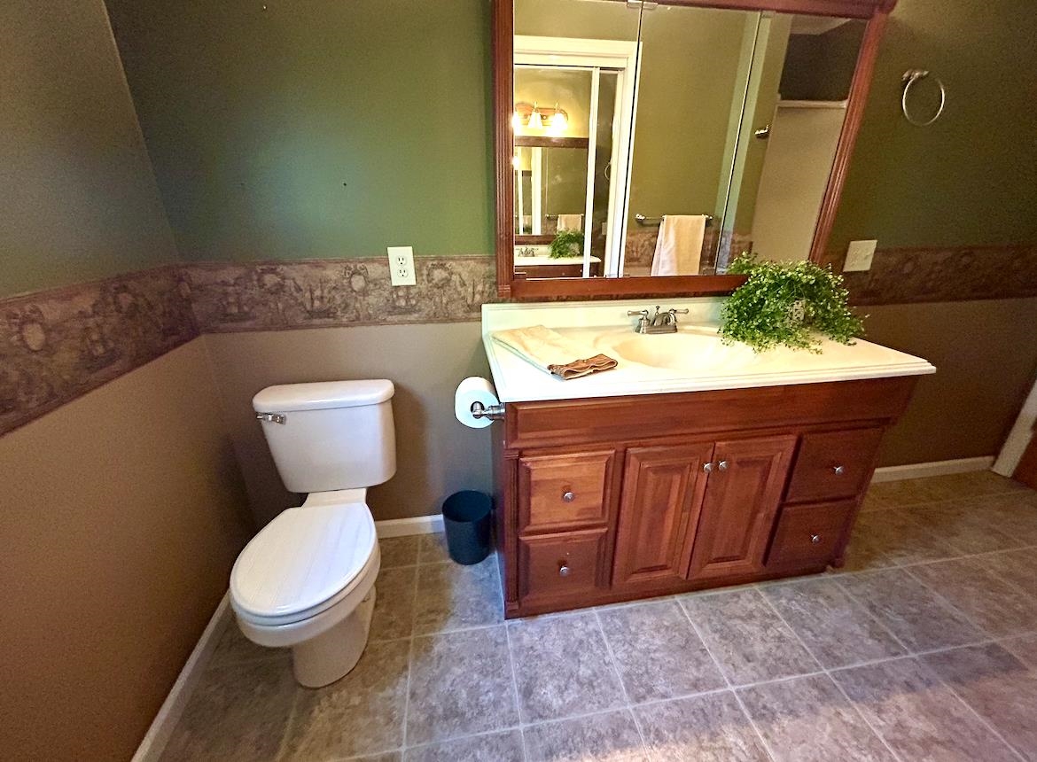 720 Riverside Lane Crump, TN 38327 - Photo 26 of 39 a bathroom with a toilet a sink and mirror