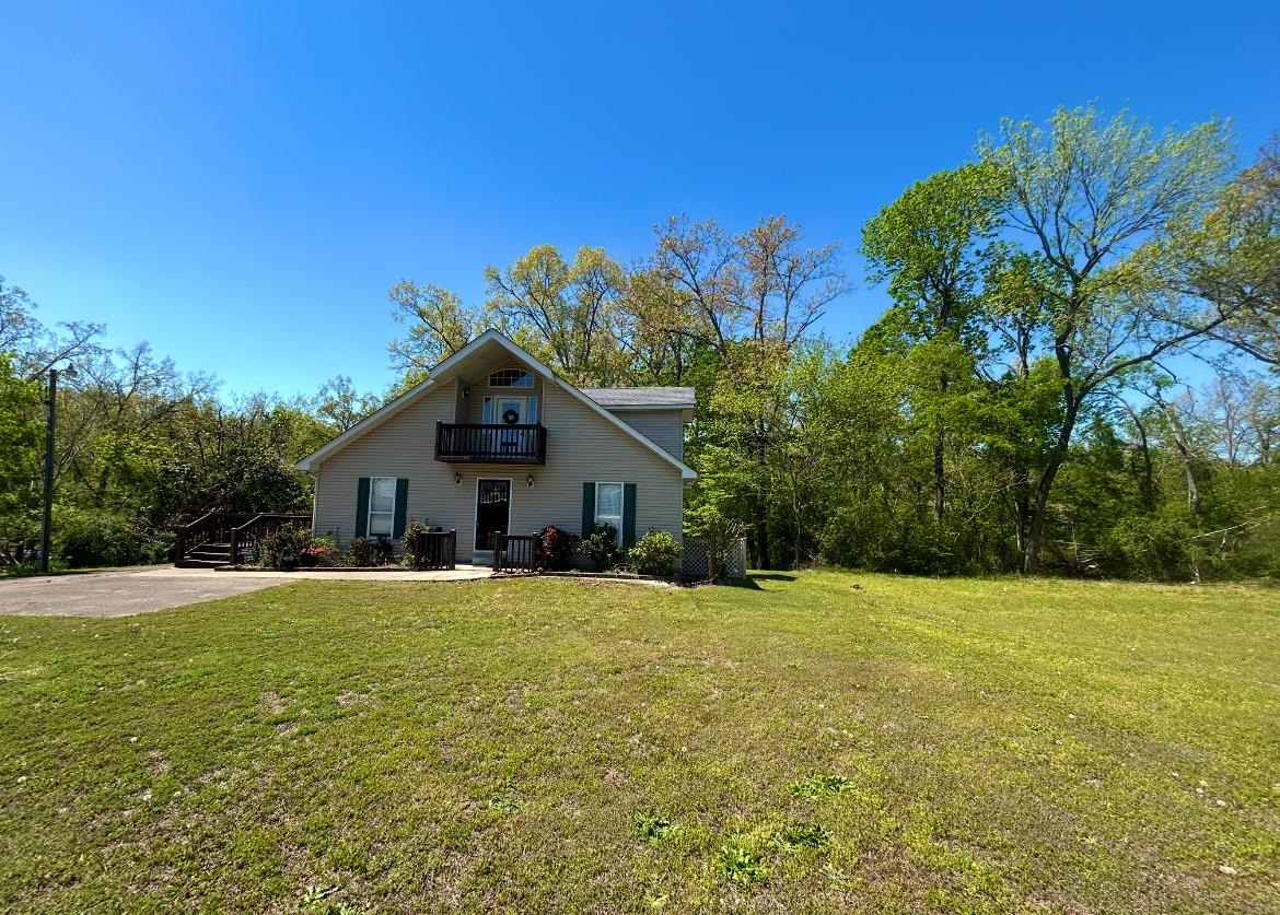 720 Riverside Lane Crump, TN 38327 - Photo 30 of 39 a house with trees in the background