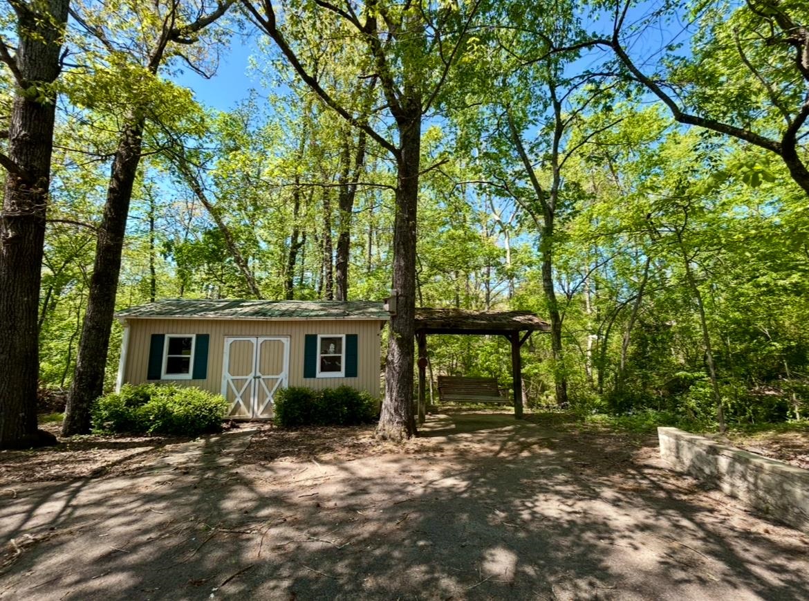 720 Riverside Lane Crump, TN 38327 - Photo 34 of 39 a view of a house with backyard and a tree