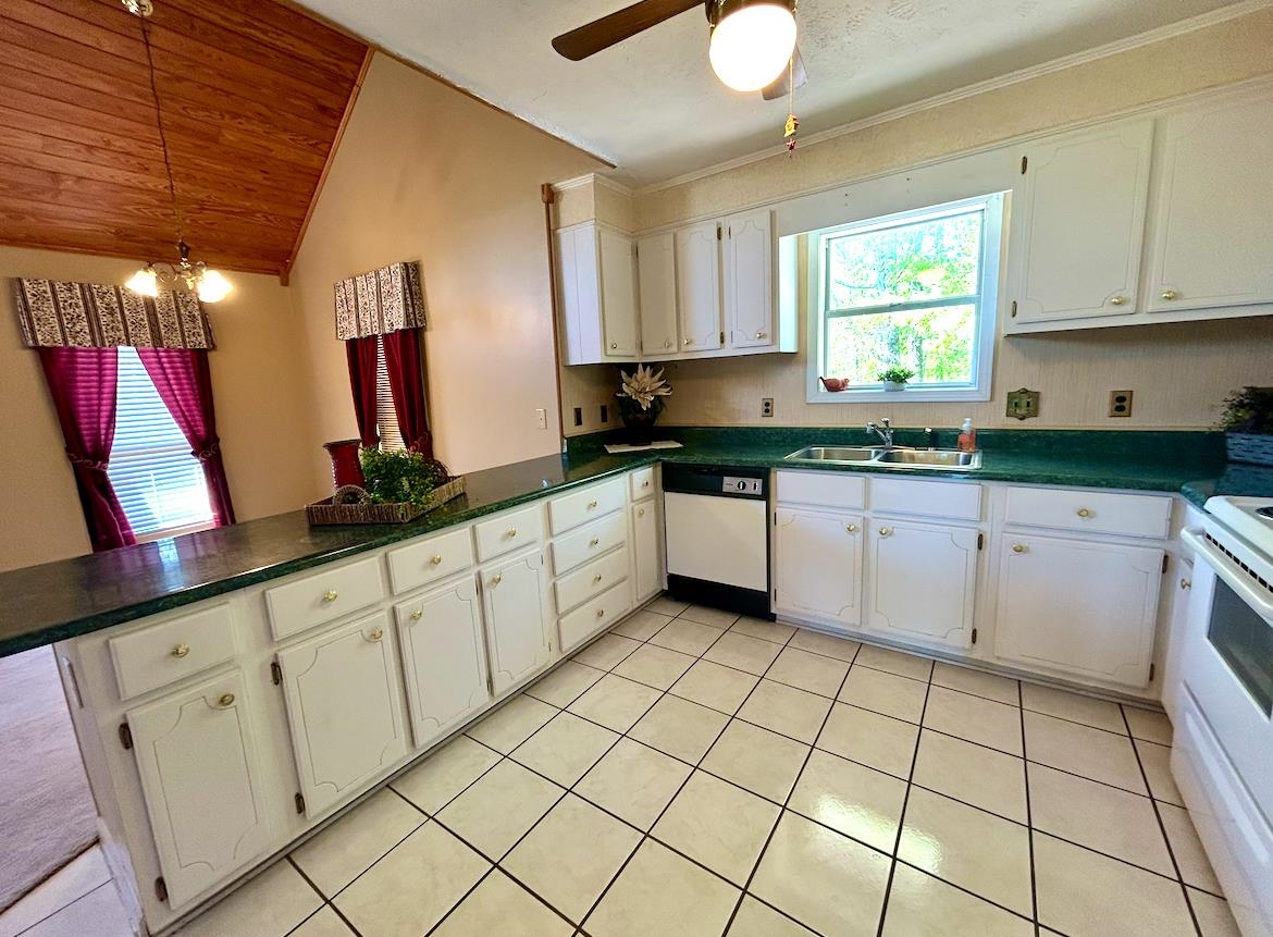 720 Riverside Lane Crump, TN 38327 - Photo 9 of 39 a kitchen with white cabinets a sink and dishwasher