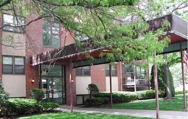 a backyard of a house with lots of green space and fountain