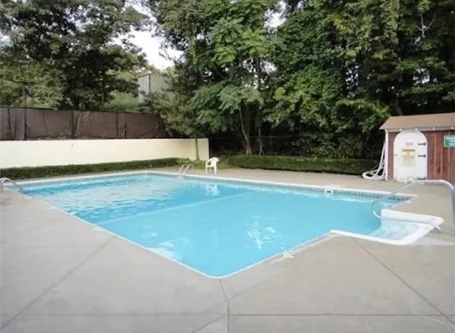 a view of swimming pool with a yard