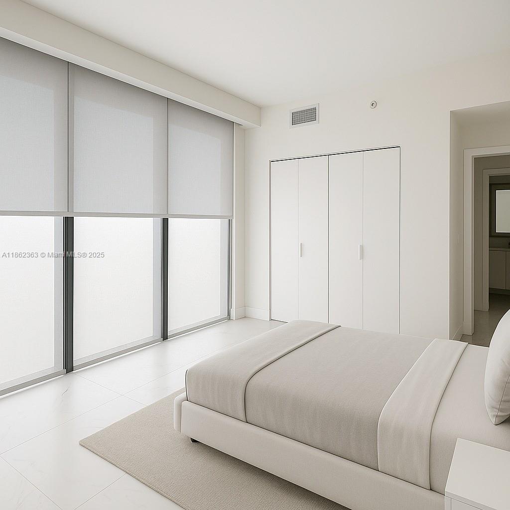 700 Northeast 24th Street, Unit 3701 Miami, FL 33137 - Photo 14 of 53 a bedroom with a bed and a refrigerator