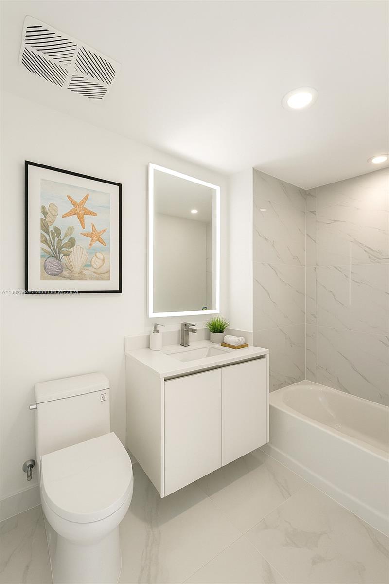 700 Northeast 24th Street, Unit 3701 Miami, FL 33137 - Photo 18 of 53 a bathroom with a toilet a sink and mirror