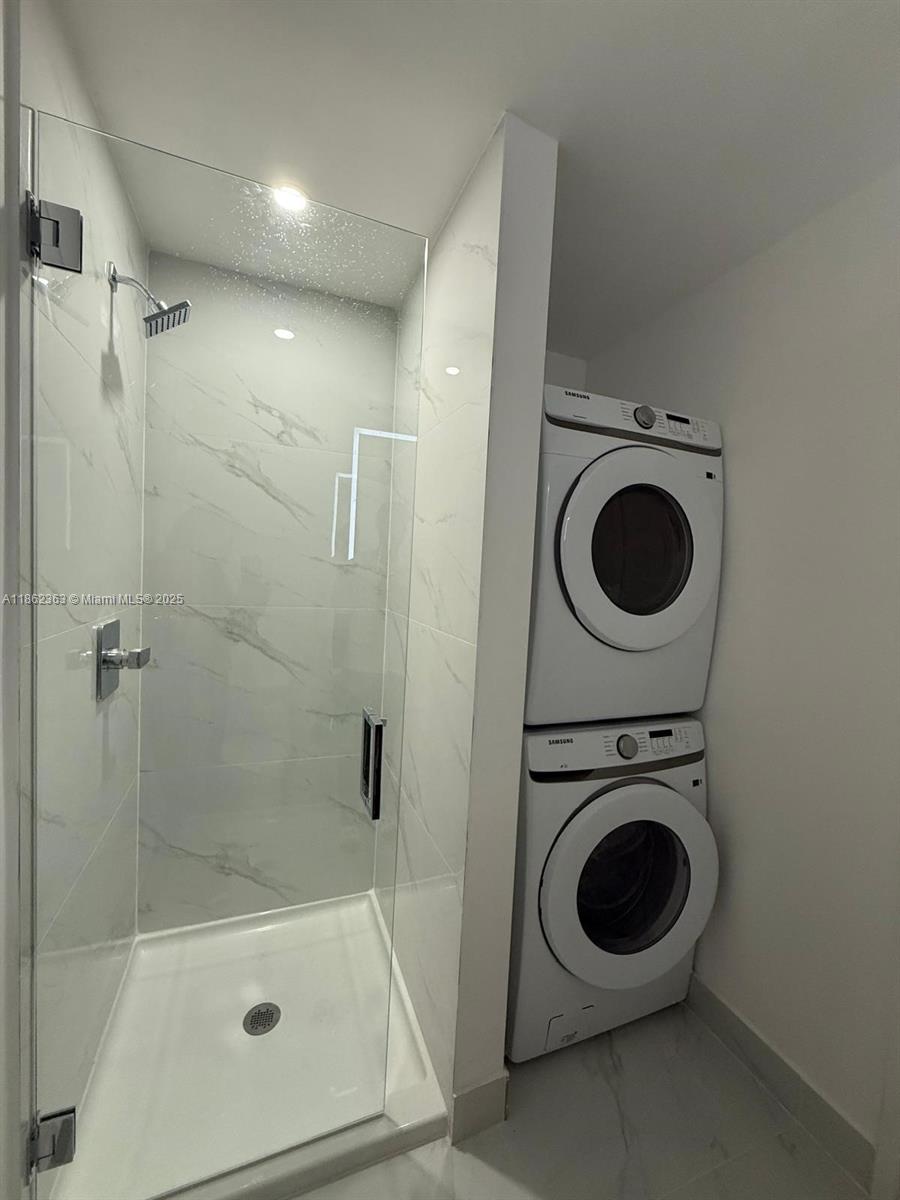 700 Northeast 24th Street, Unit 3701 Miami, FL 33137 - Photo 20 of 53 a view of a bathroom with a washer and dryer
