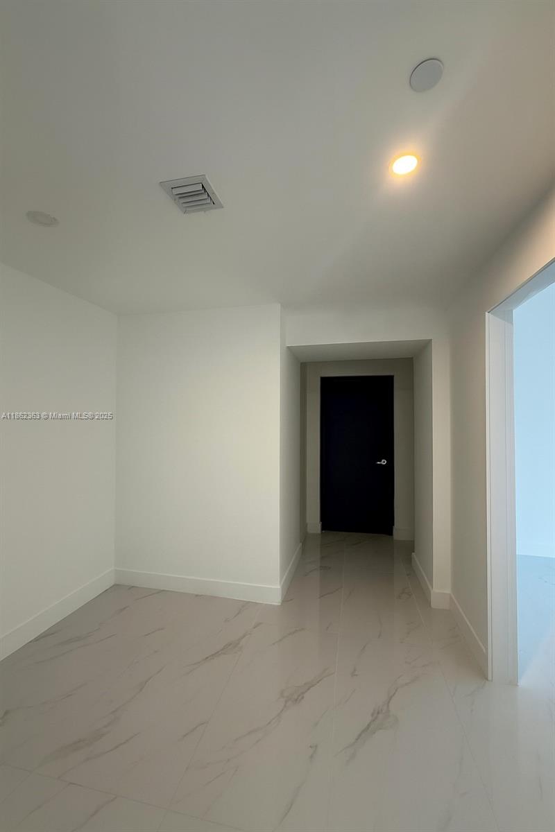 700 Northeast 24th Street, Unit 3701 Miami, FL 33137 - Photo 23 of 53 an empty room with a natural light