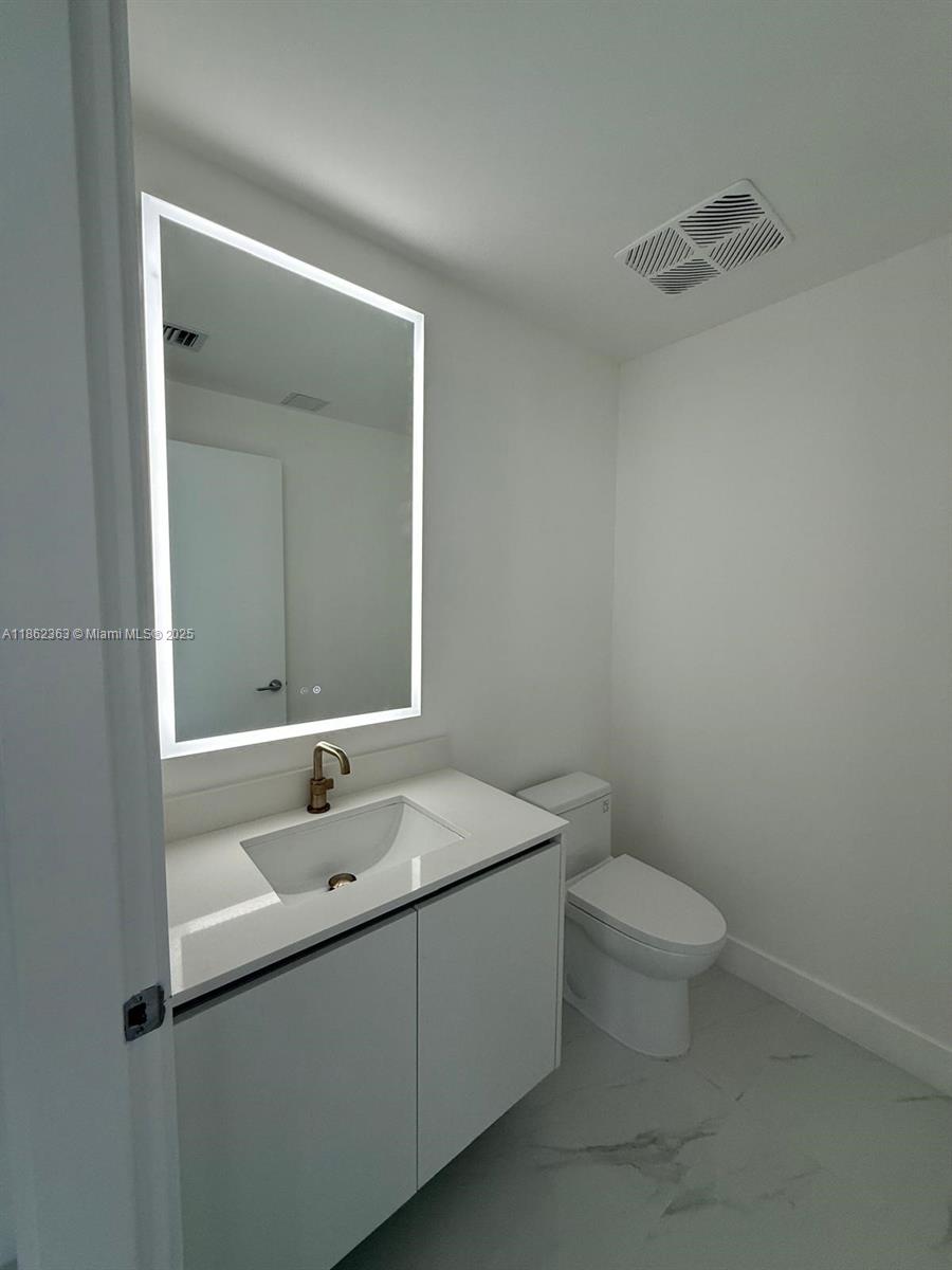 700 Northeast 24th Street, Unit 3701 Miami, FL 33137 - Photo 28 of 53 a bathroom with a sink and a toilet