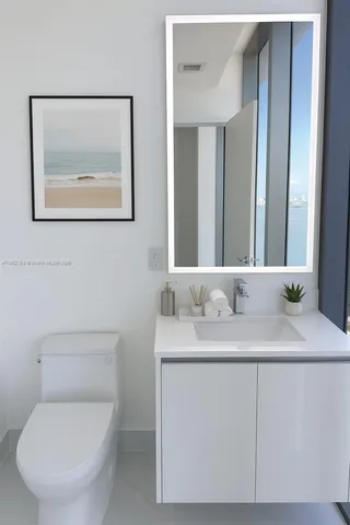 a bathroom with a toilet a sink and mirror