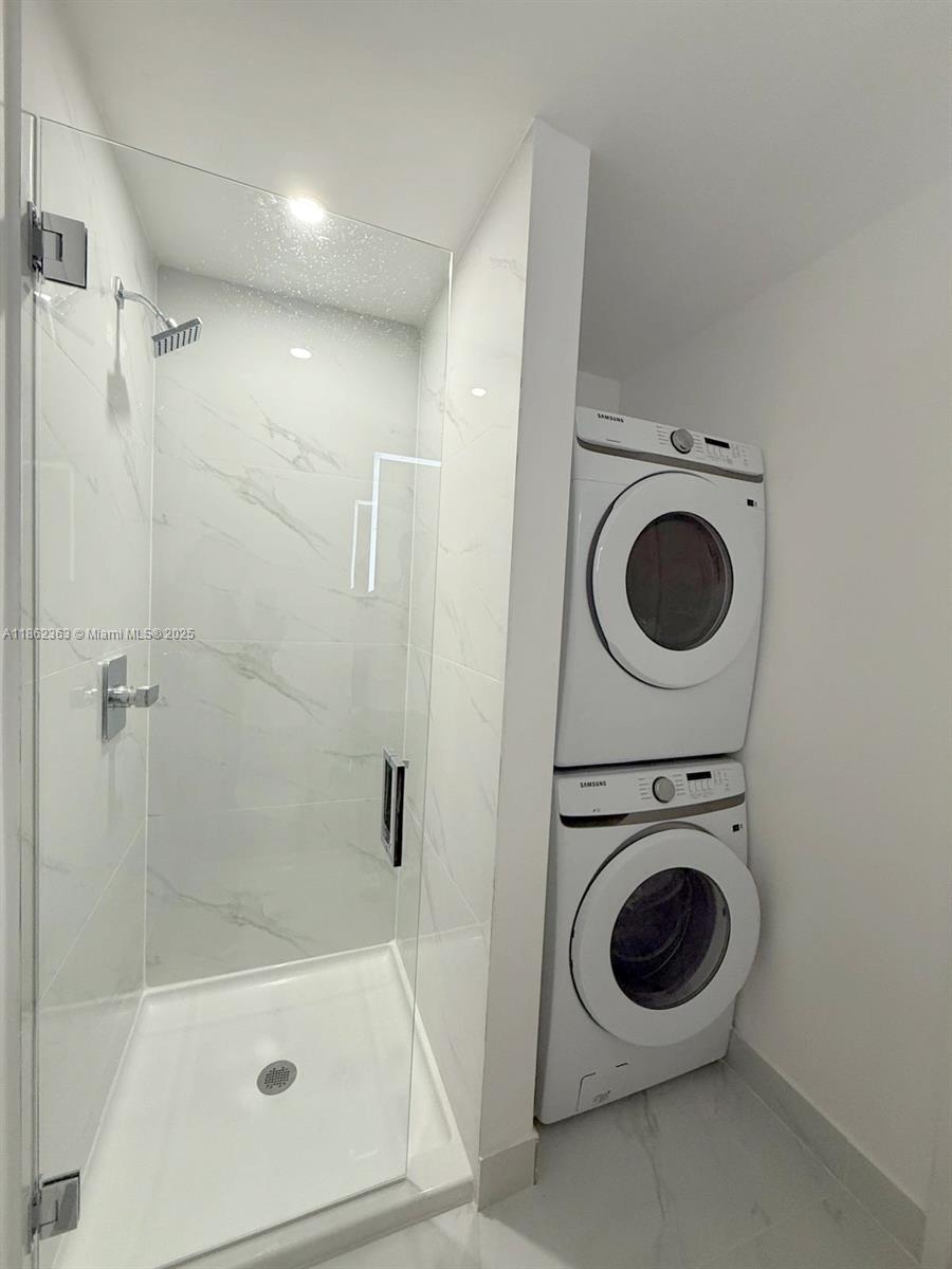 700 Northeast 24th Street, Unit 3701 Miami, FL 33137 - Photo 35 of 53 a view of a bathroom with a washer and dryer