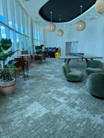 a view of swimming pool with lounge chair and fire pit