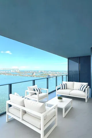 a view of a terrace with couches and lounge chairs