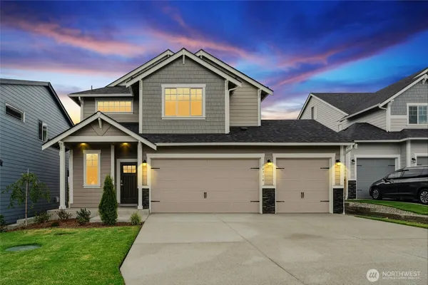 a front view of a house with a yard and garage